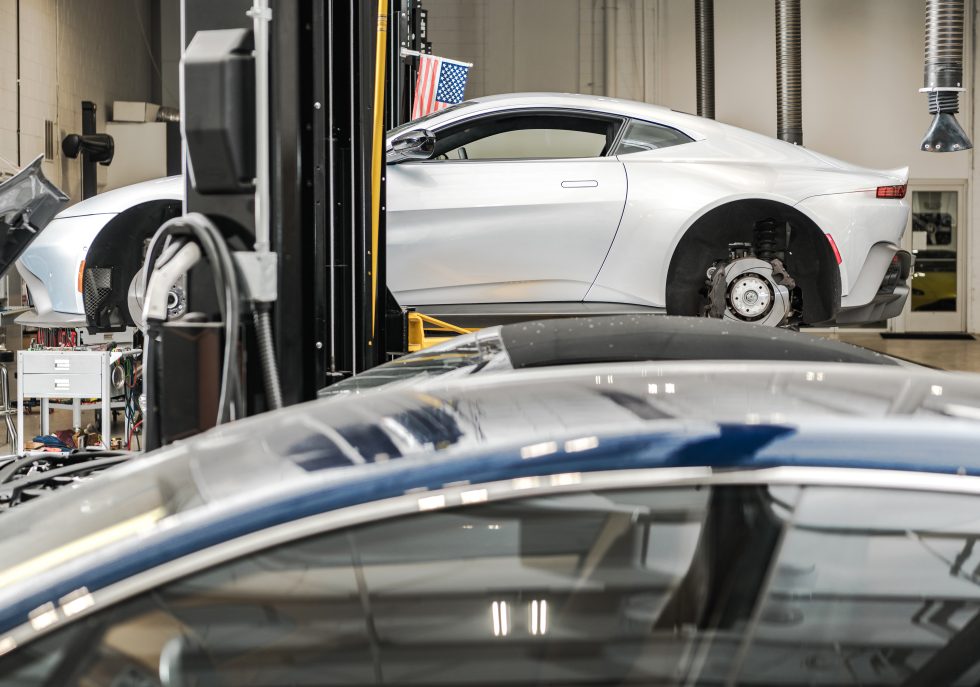 "A technician carefully removing a dent from a classic car using PDR."