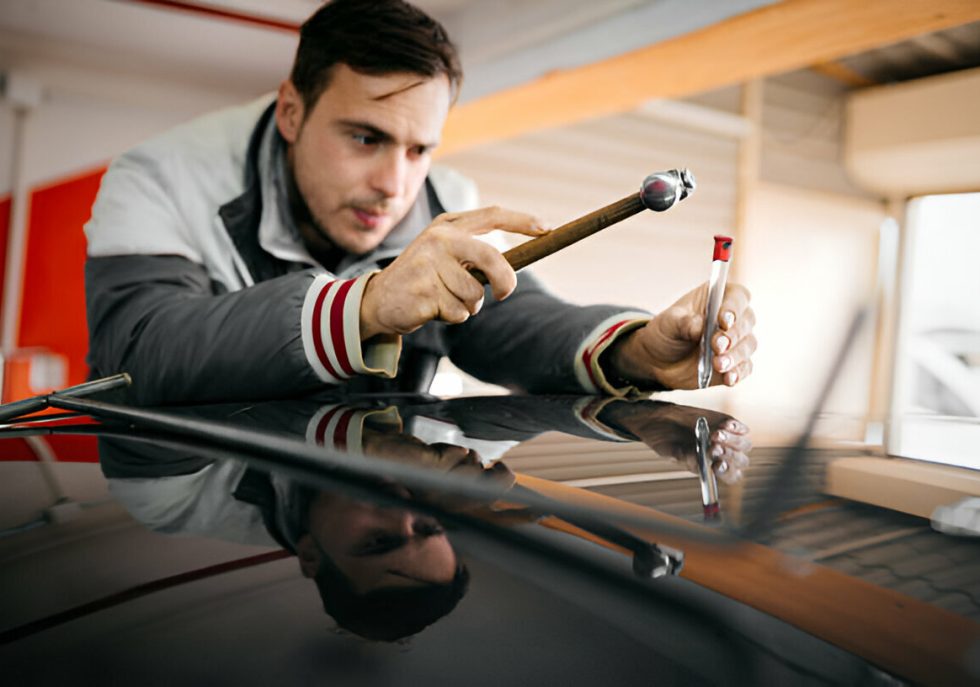 A leased car undergoing paintless dent repair before return."