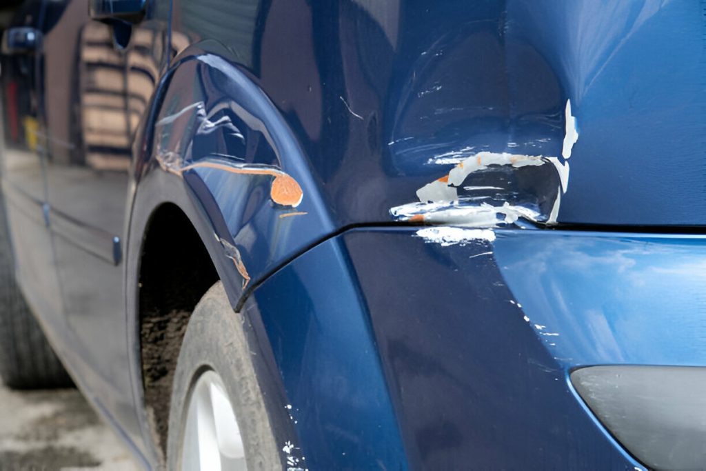 "A technician performing Paintless Dent Repair (PDR) on a car panel
