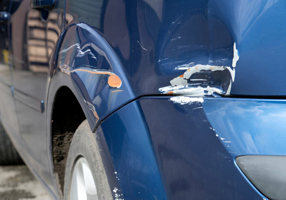 "A technician performing Paintless Dent Repair (PDR) on a car panel
