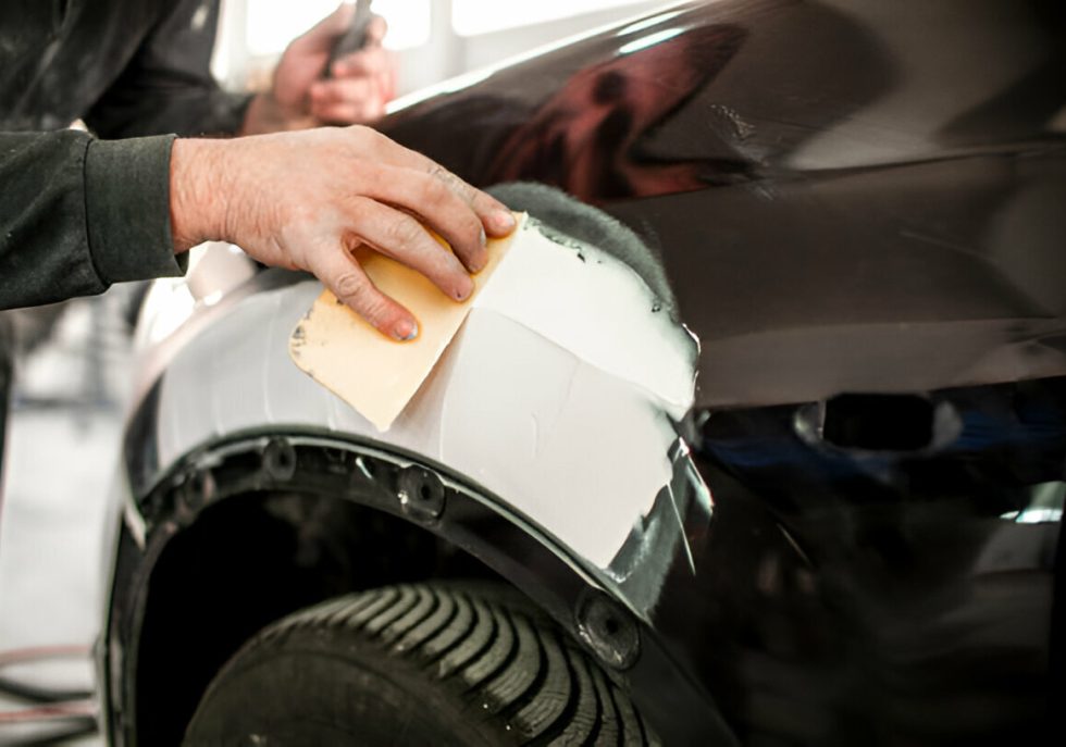 "A mobile PDR technician performing dent repair on-site."