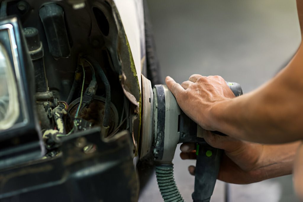A classic car undergoing paintless dent repair."