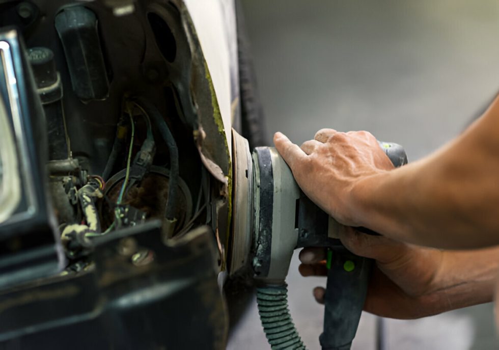A classic car undergoing paintless dent repair."