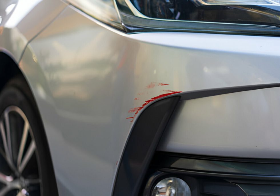 "Technician performing Paintless Dent Repair (PDR) on a car fender."