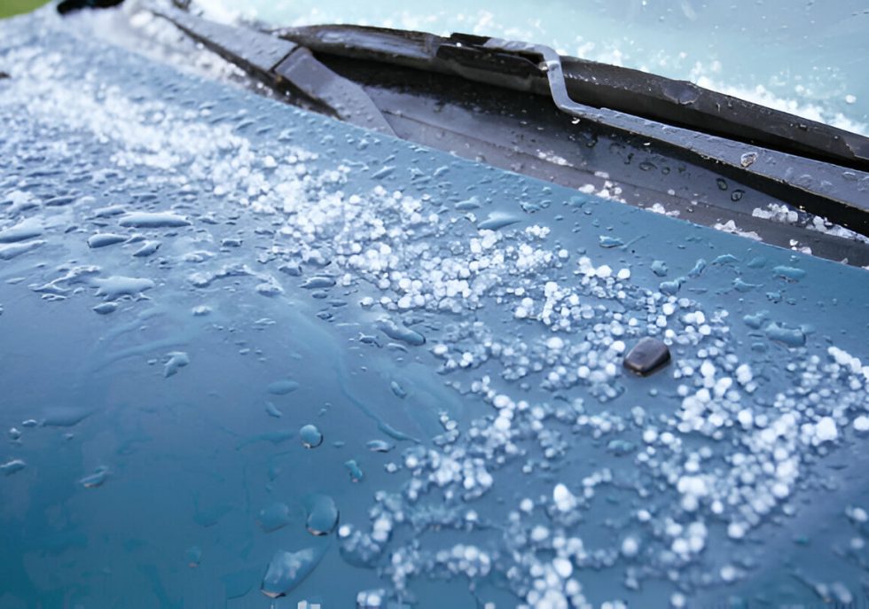 "Technician performing Paintless Dent Repair (PDR) on a hail-damaged car."