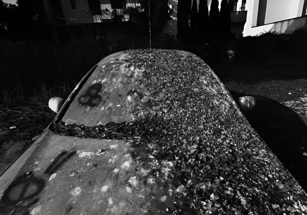 "Car with hail dents being inspected for Paintless Dent Repair."