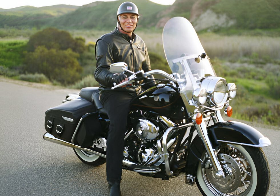 "Motorcycle fuel tank being repaired using Paintless Dent Repair (PDR) techniques."