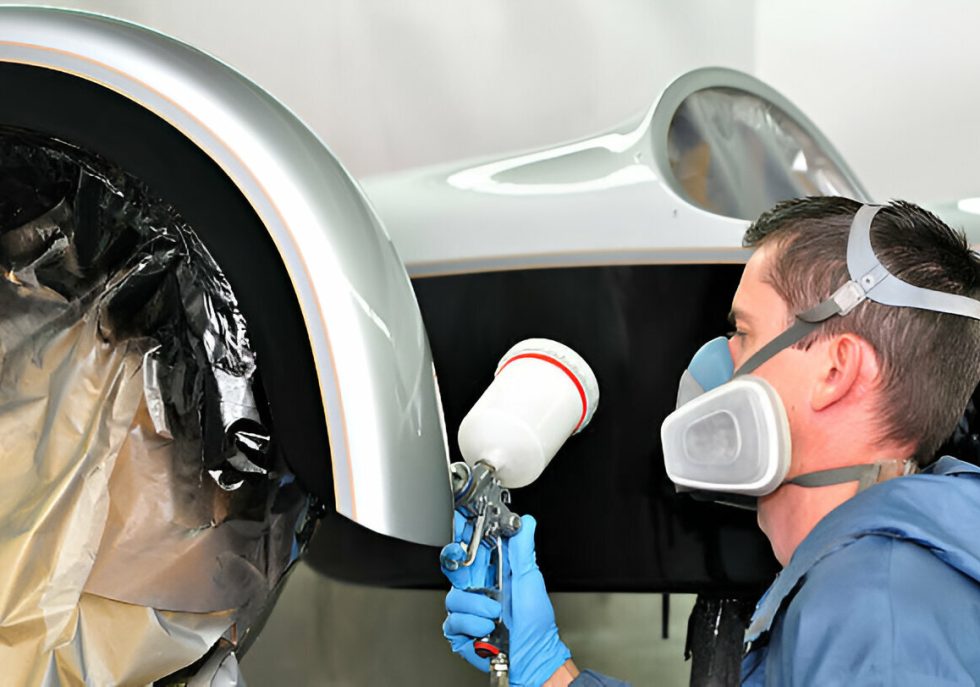 "A mobile dent repair technician working on a car at a customer’s location."