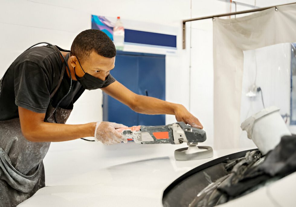 A car parked in a tight garage with foam padding on the walls to prevent door dings."